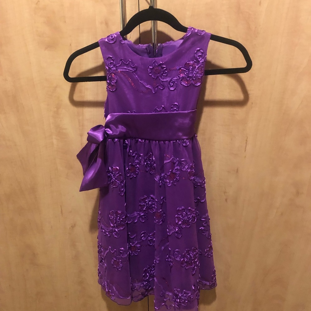 Purple with sequins. Beautiful party dress. Used once for a piano recital.